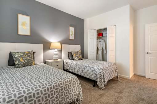 a bedroom with two beds and a closet at Pier Village Apartments, Long Branch, 07740