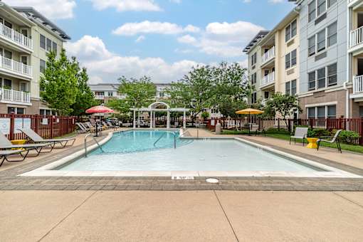 our apartments feature a swimming pool and a patio with umbrellas at Pier Village Apartments, Long Branch, New Jersey
