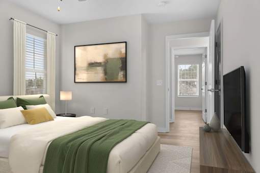 A bedroom with a large bed and a painting on the wall at Grand at Pearl Apartments, Pearl, MS 39208