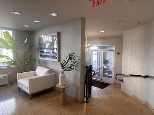 a view of the lobby of an office building with a white chair and a plant at Pier Village Apartments, Long Branch, 07740