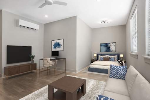 A modern living room with a television, a desk, a bed, and a couch. at Midtown Row, Alabama, 36106