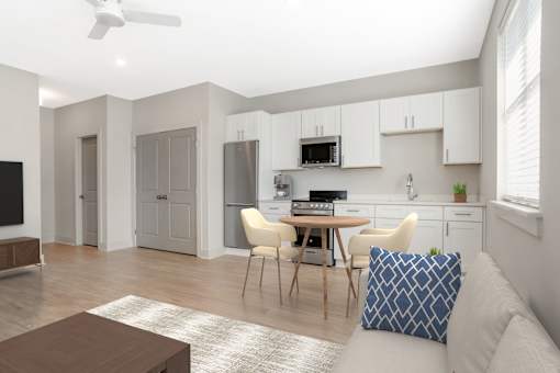 A modern kitchen with a dining table and chairs. at Midtown Row, Montgomery, AL, 36106