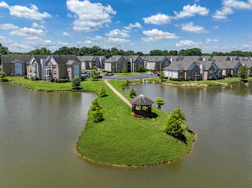 a small island with a gazebo in the middle of a lake at North Creek, Southaven