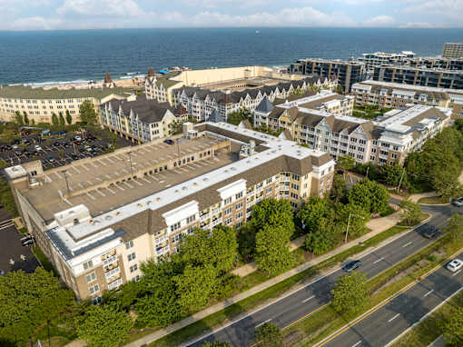 an aerial view of a city with buildings and the ocean at Pier Village Apartments, New Jersey