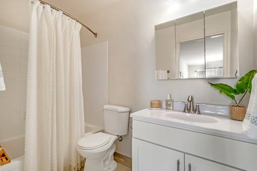a bathroom with a sink toilet and a shower curtain at Quail Ridge, Plainsboro Township, NJ