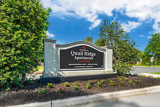 a sign apartments in front of trees at Quail Ridge, Plainsboro Township