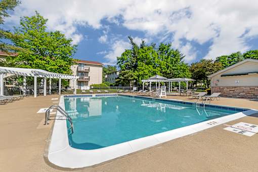 our resort style swimming pool is next to our building with trees at Quail Ridge, New Jersey