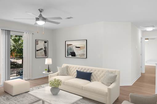 A living room with a white couch and a ceiling fan. at Reflection Pointe, Flowood, MS, 39232