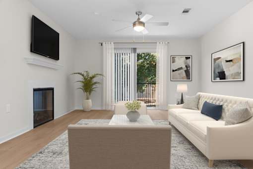 A living room with a white couch, a coffee table, a flat screen TV, and a ceiling fan. at Reflection Pointe, Flowood, 39232