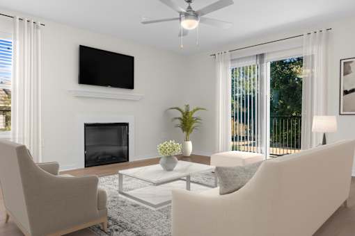 A living room with a fireplace, two chairs, a sofa, and a television. at Reflection Pointe, Mississippi