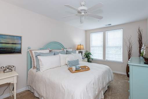Bedroom with cozy bed at River House Apartments, Norfolk, Virginia