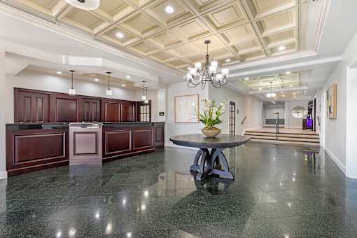 A spacious kitchen with dark wood cabinets and a marble countertop.