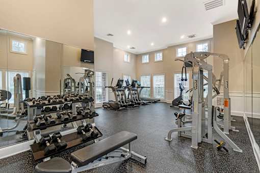 A spacious home gym with a variety of exercise equipment.