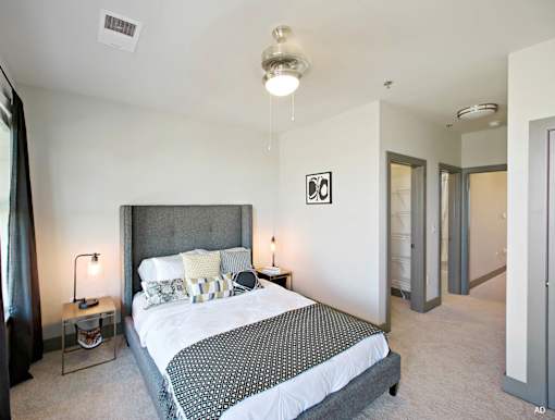 a bedroom with a bed and two nightstands at The Addison, Baton Rouge, Louisiana