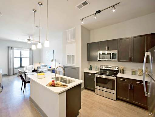 a kitchen with a large island and stainless steel appliances at The Addison, Baton Rouge, 70836