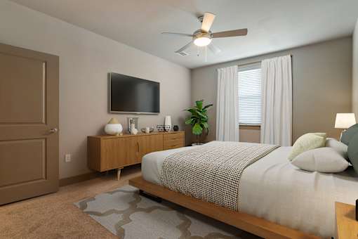 Bedroom with TV and ceiling fan at The Cosmopolitan, Tulsa, 74119