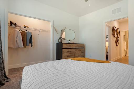 Bedroom with lamps and bed at The Mason at Fremaux Park, Louisiana