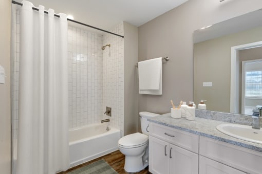 a bathroom with a shower and a toilet and a sink