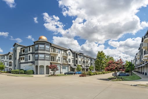 a large apartment building on the corner of a street
