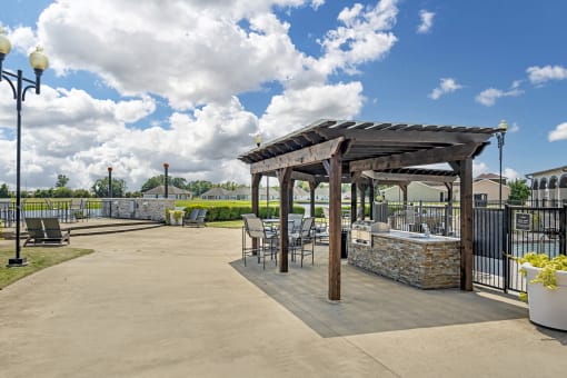 an outdoor patio with tables and chairs and a pergola