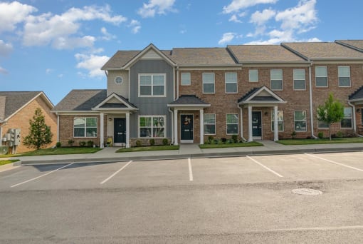 a large brick building with a parking lot in front of it