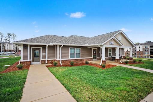 A house with a brown roof and a grey front porch.