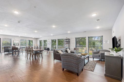 a living room and dining room with a table and chairs