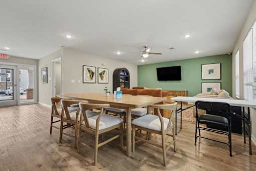 A room with a long table and chairs.