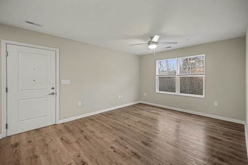 A room with a white door and a window with a white frame.