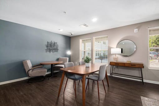 a dining room with a table and chairs and a mirror