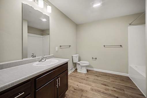 A bathroom with a sink, toilet, and a tub.