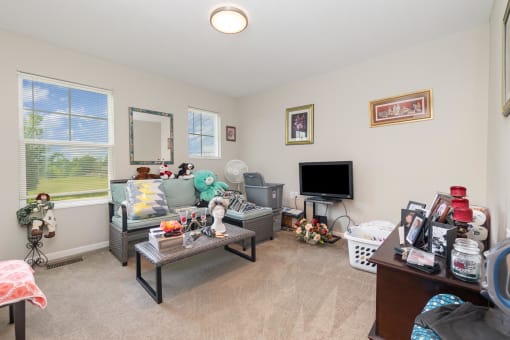 a living room filled with furniture and a flat screen tv