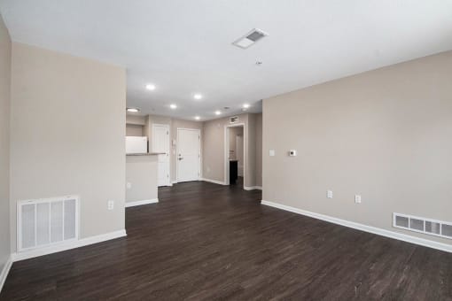 the living room and kitchen of a new home with wood flooring