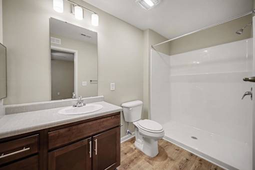 A bathroom with a white toilet and a white bathtub.