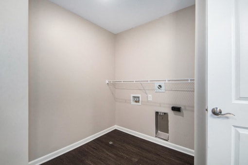 a empty room with a white wall and a white door