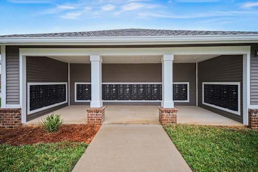 A house with a covered porch and a walkway leading to the front door.