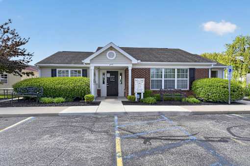A building with a parking lot in front of it.