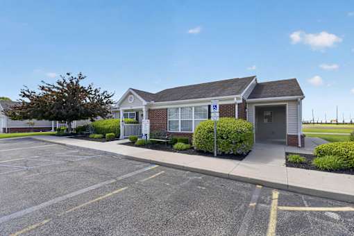 A small building with a parking lot in front.