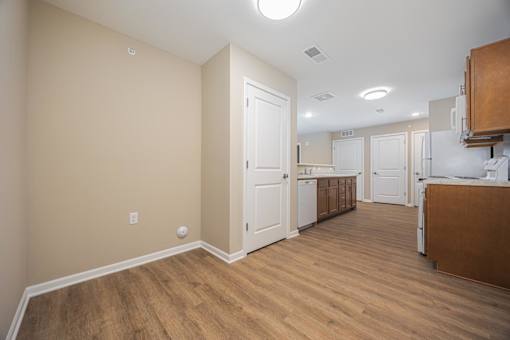 A kitchen area with a white door and a counter.