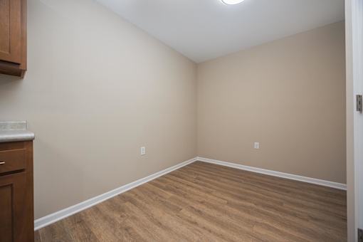 A room with wooden flooring and a white ceiling.