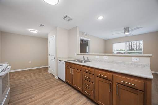 A kitchen with wooden floors and white appliances.