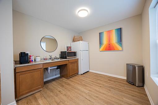 A kitchen with wooden cabinets and a fridge.
