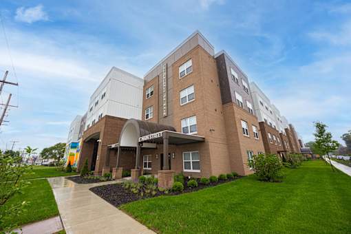 A brown building with a walkway in front of it.