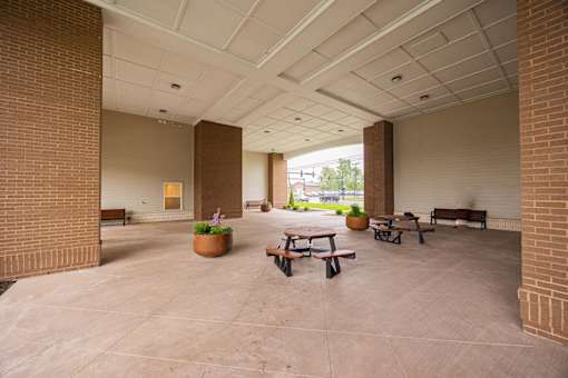 A large open space with benches and a planter.