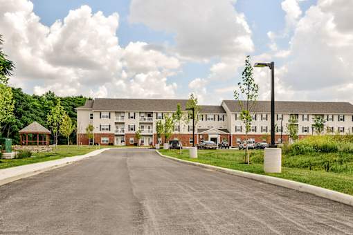 A large building with a parking lot in front of it.