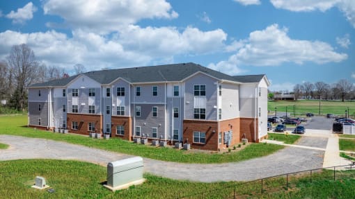 an apartment building with a driveway and a parking lot