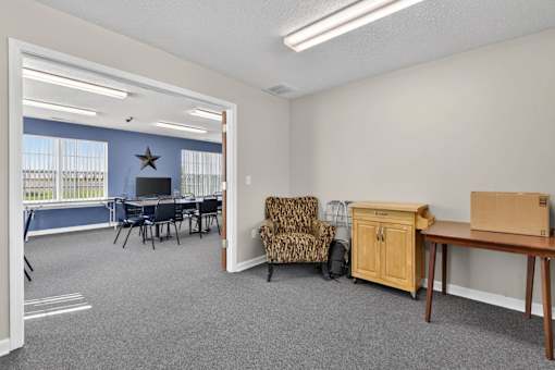 A room with a dining table, chairs, and a couch.