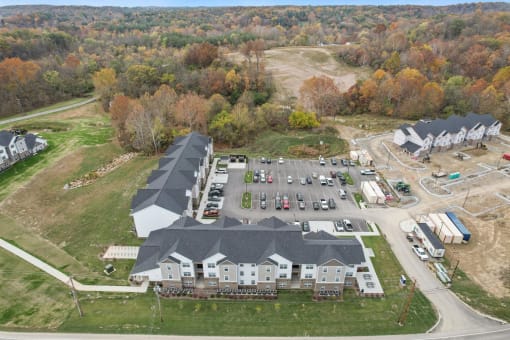 a view from above of a large building with a parking lot and other buildings