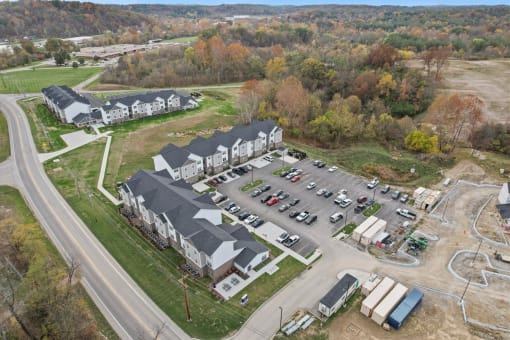 an aerial view of a parking lot and houses