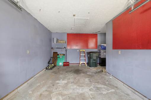 A room with a red wall and a ladder.